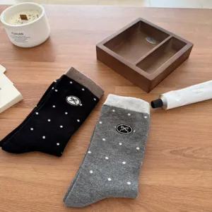 Women's autumn cute polka dot embroidered bow mid tube socks in black and grey colors.