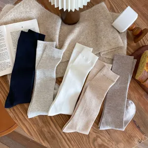 Detailed view of Korean style solid color long socks for women, soft knit autumn winter calf socks.