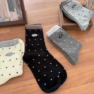 Detailed view of women cute polka dot socks with bow embroidery, soft cotton mid tube style.