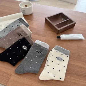 Women's cute polka dot mid-tube socks with embroidered bow design, comfortable autumn wear.