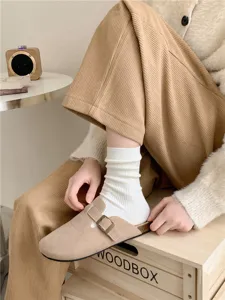 Detail shot of women's white ribbed mid-tube socks paired with cozy autumn styling.