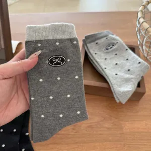 Autumn women's cute mid-calf socks featuring grey polka dots and sweet embroidered bow design.