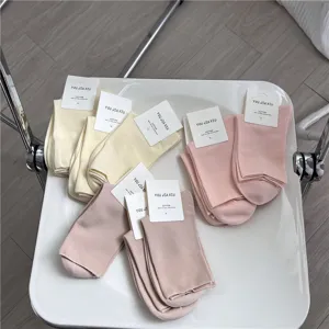 Warm color cotton mid-tube women socks with soft loose top detail shot, comfortable daily wear.