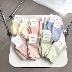 Comfortable cotton mid-tube women socks in multiple sweet colors with tags for daily wear.