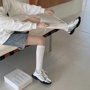 Korean style solid color high tube socks for women, comfortable autumn and winter leg wear detail.