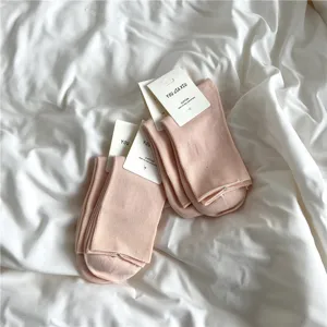 Comfortable pink cotton mid-calf socks for women, soft and cozy daily casual wear item.