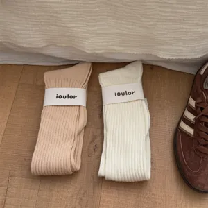 Solid color long slouch knit socks detail view, cozy winter casual ribbed hosiery style.