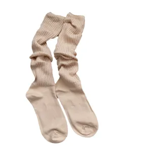 Beige long slouch socks for women, cozy knit ribbed calf socks, stylish casual autumn winter wear.