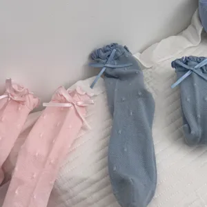 Detailed view of women cute ruffles bowknot polka dot mid-tube cotton socks breathable soft.