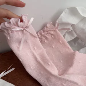 Pink ruffle mid-calf socks for women with cute bows and polka dot pattern, sweet spring style.
