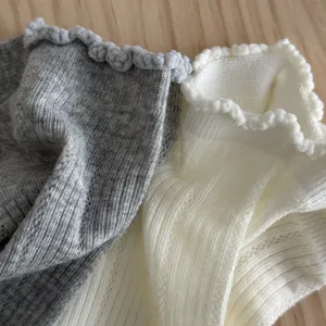 Fine knit detail of women's short socks featuring breathable mesh and cute lettuce edge.