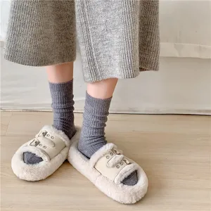 Detailed view of cozy grey ribbed wool stack socks paired with plush slippers, soft texture.