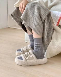Cozy autumn winter knit wool socks paired with fluffy plush double buckle slippers.