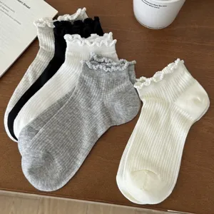 Detail view of women's short socks with ruffled lace edges and breathable mesh knit design.