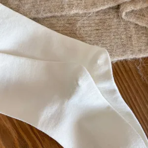Solid color long tube socks detail view, soft cotton fabric texture, comfortable daily wear.