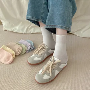Comfortable long-staple cotton mid-calf women socks paired with stylish retro casual sneakers.
