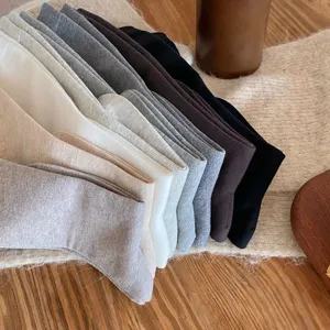 Solid color long knee high socks for women, cozy winter daily wear hosiery and stockings.