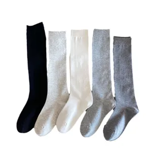 Solid color long knee high socks for women, comfortable cotton knit warm winter hosiery.