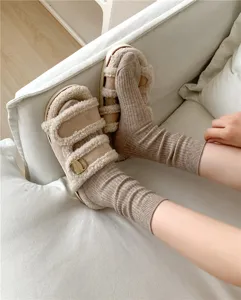 Cozy fuzzy sandals paired with ribbed knit crew socks, perfect for autumn and winter daily wear.