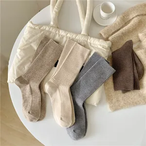 Casual vertical striped wool mid-tube socks detail shot, Japanese retro style cozy autumn wear.