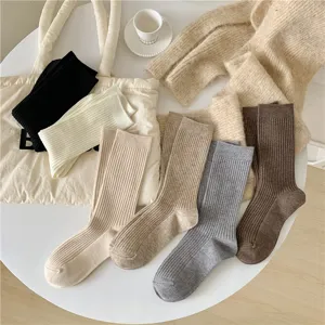 Detailed view of autumn and winter solid color ribbed knit mid-tube socks in various cozy colors.
