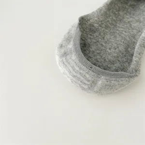 Detailed shot of grey cotton split toe invisible low cut socks with anti slip grip texture.