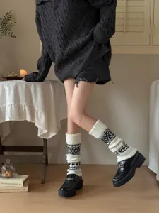 Close-up detail of women's autumn winter Fair Isle knit leg warmers retro diamond pattern.