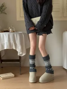 Detail shot of retro grey fair isle knit leg warmers, showing cozy wool texture and pattern.