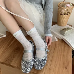 Japanese style hollow out cotton mid-calf socks for women with cute woven label design.