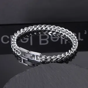 Stainless steel Franco Cuban chain bracelet for men with secure folding clasp detail.