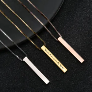 Close-up of minimalist stainless steel bar pendant necklaces in silver, gold, and rose gold.