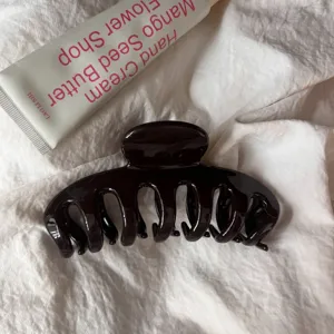 Minimalist dark brown hair claw clip for women, elegant daily hair styling accessory. detail view
