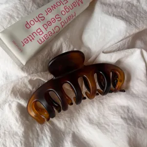 Brown resin hair claw clip large hollow shark clip minimalist daily hair styling accessory.