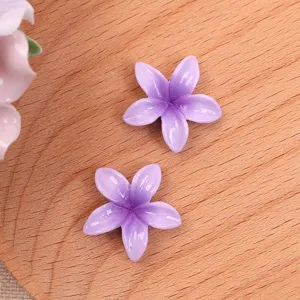 Purple resin plumeria flower cabochons for DIY crafts, earrings, and hair accessories.