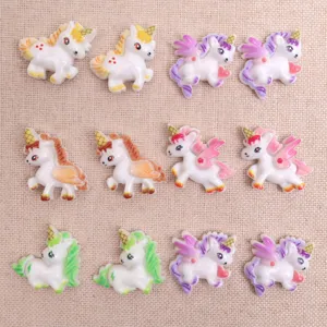 Close-up of cute resin unicorn and pegasus charms, perfect for DIY phone cases and crafts.