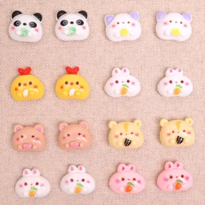 Close-up detail of cute cartoon animal resin cabochons holding food for DIY crafts accessories.
