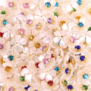 Pearl flower rhinestone DIY craft accessory detail shot, sparkling colorful stones set in white floral resin.