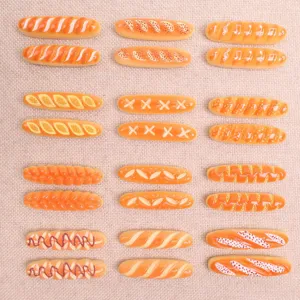 Detailed view of resin baguette bread cabochons, cute miniature DIY charms for crafts and phone cases.