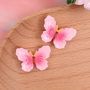 Resin butterfly DIY phone case charm, pink gradient hairpin accessory, craft decor detail.