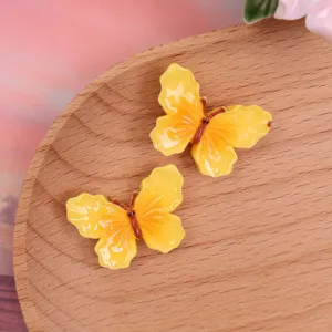Resin yellow butterfly charms, glossy DIY phone case accessories, cute craft supplies.