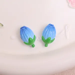 Blue tulip resin flower charm detail view, cute DIY accessory for phone case and crafts.