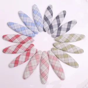Detailed view of colorful plaid oval fabric patches, DIY hair accessories and craft parts.