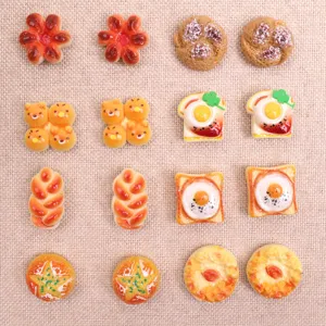Closeup of miniature resin bread cabochons, cute DIY charms for phone cases and hair clips.