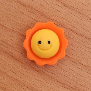 Resin sun smiley face charm detail view, perfect for DIY handmade crafts and phone case decor.