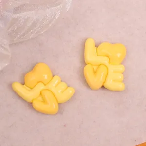 Glossy yellow resin LOVE letter charm, perfect for DIY handmade hair clips and phone case decor.