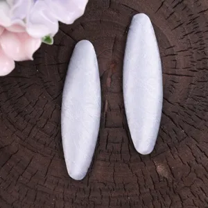 Close-up detail of Korean style handmade fabric hair clips in cream color, oval shape set.
