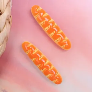 Resin baguette bread charm detail shot, cute DIY hair clip and phone case decoration.