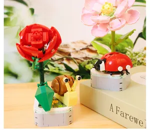 DIY botanical building blocks set featuring flowers, snail, and ladybug desktop toys.