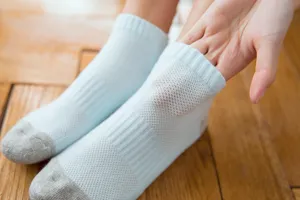 Close-up view of light blue mesh ankle socks with towel bottom showing breathable fabric and details.