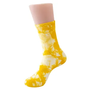 Close-up view of the yellow and white tie-dye mid-calf sock, showing soft cotton fabric texture.